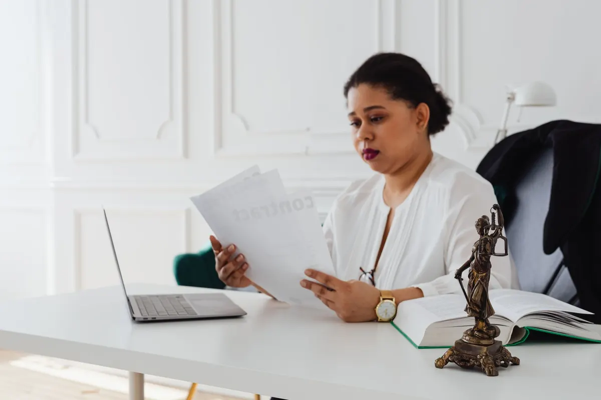 Attorney reviewing printed legal documents at an office desk