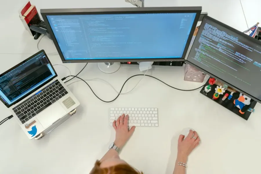 Senior engineer working across multiple code screens