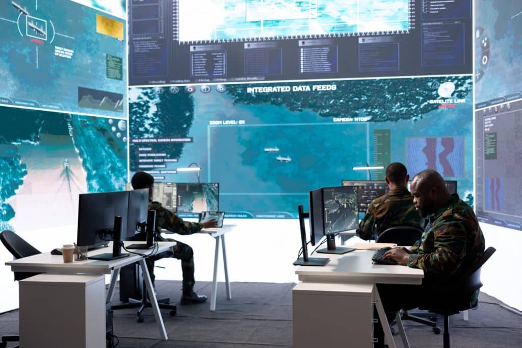 Army staff in a high tech control room managing crucial defense information