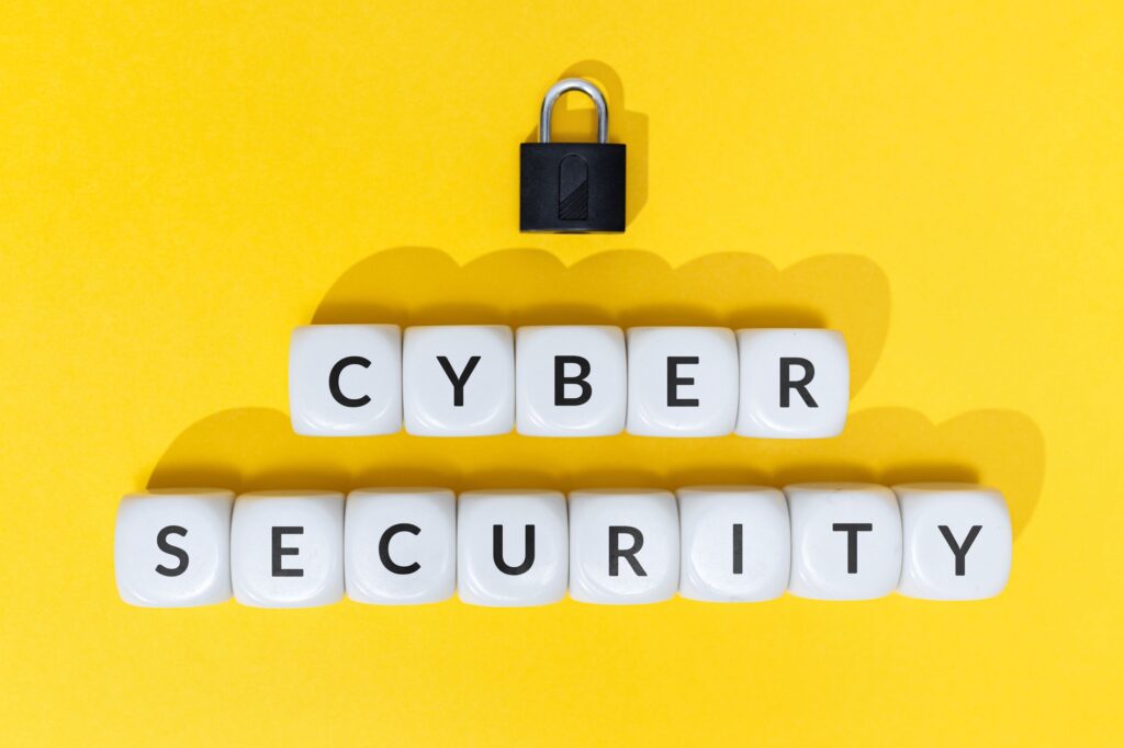 Cyber security Text on blocks and padlock on yellow background