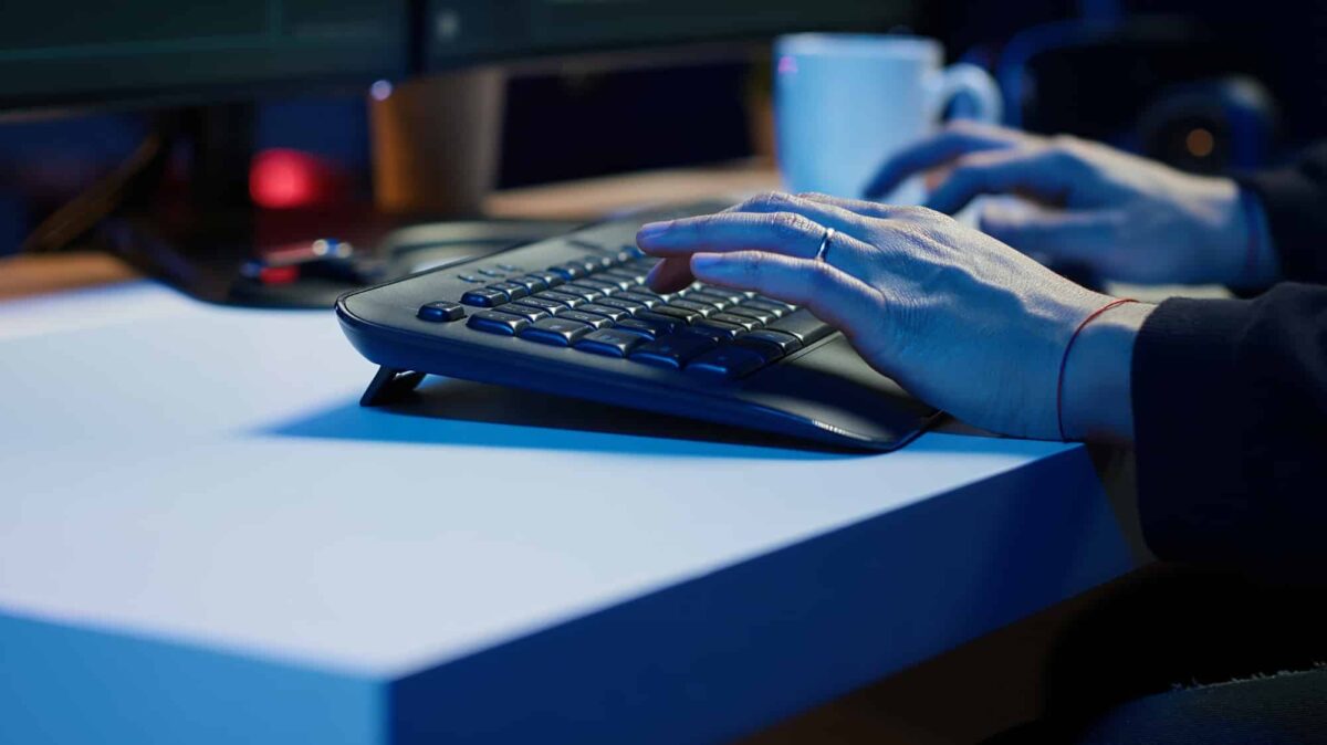 Cybercriminal breaching security systems while hiding in secret HQ, close up