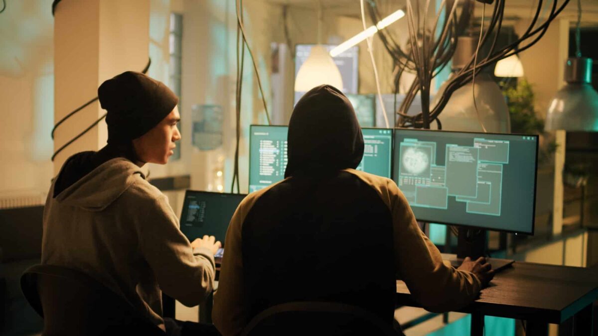 Hackers team working together to break security system on computer