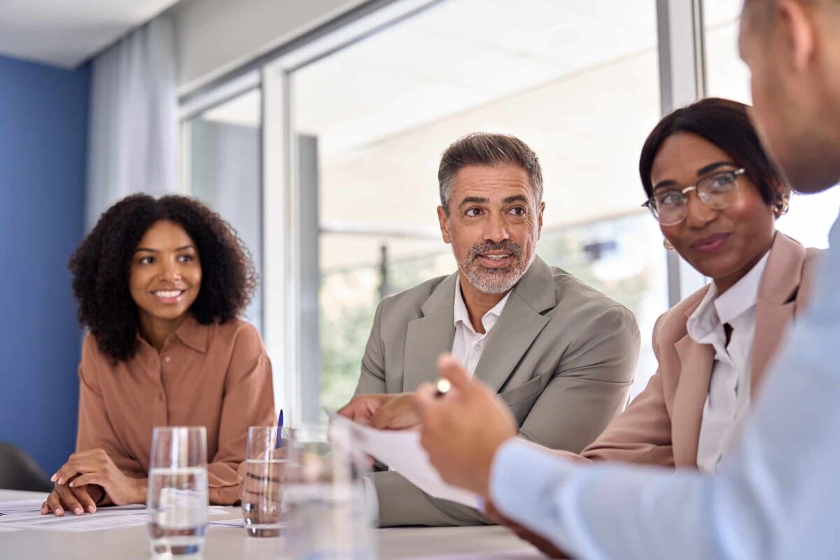 Older leader manager consulting managing busy team work at office meeting.