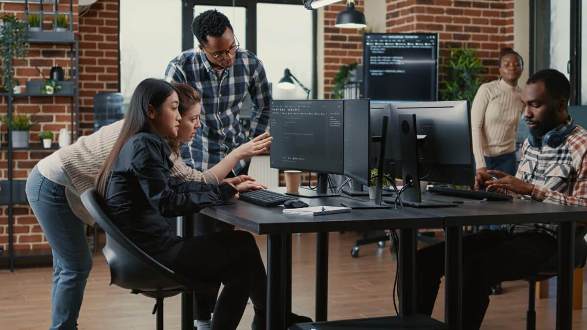 Programmers collaborating on group project compiling algorithm for new cloud computing interface