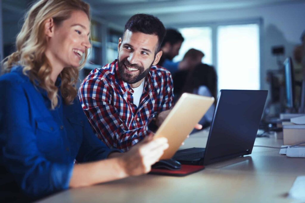 Programmers cooperating at information technology company