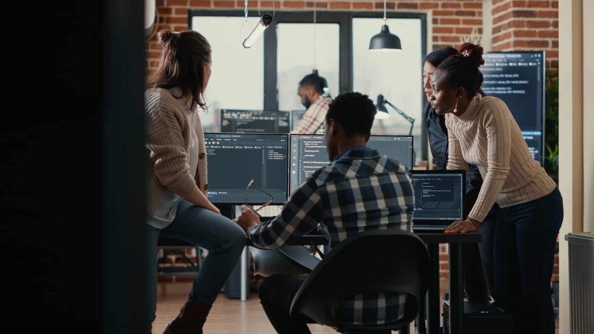 Software programmers discussing about online cloud computing while the rest of the team joins