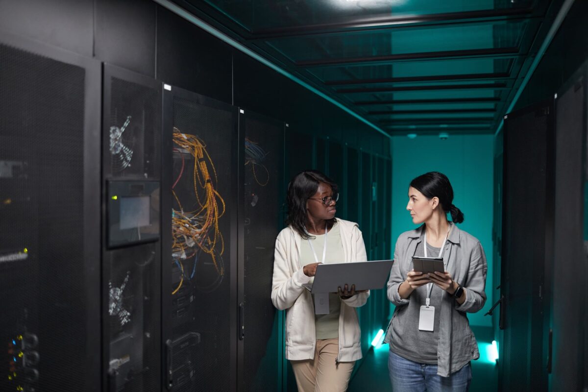 Two Women Managing Servers in Data Center