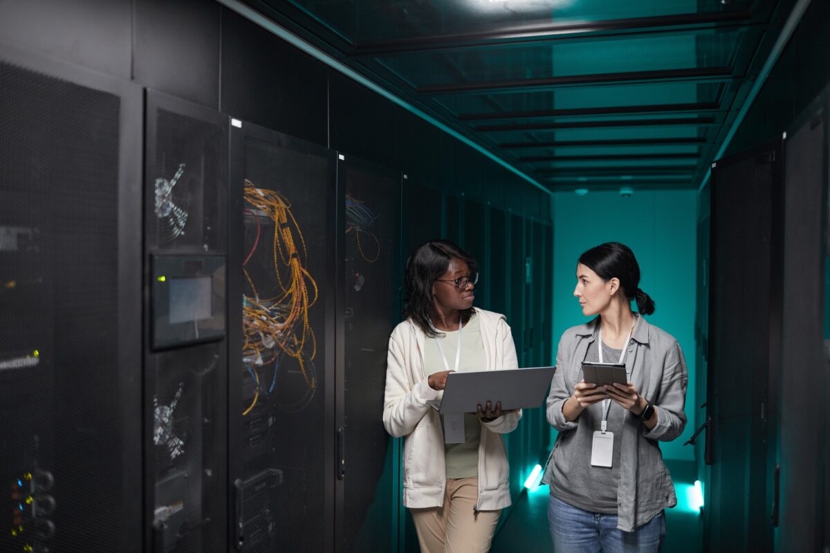 Two Women Managing Servers in Data Center